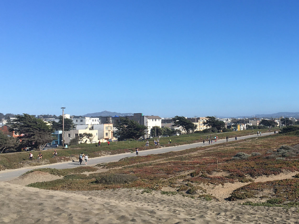 People walk on the beachside Great Highway, closed to cars.