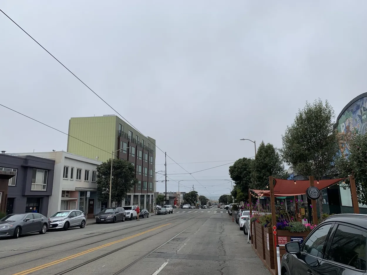 A street in the Sunset District on an overcast day, looking downhill toward the ocean.